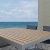 Designer outdoor table in teak and stainless steel